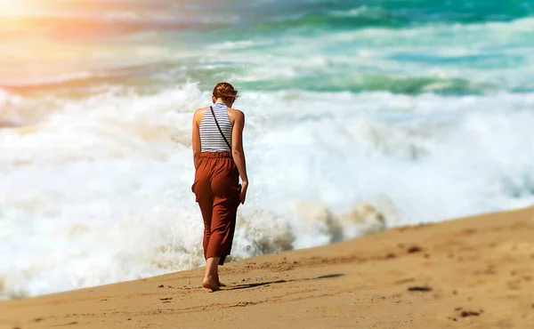 Alone walking on the beach on a sunny morning