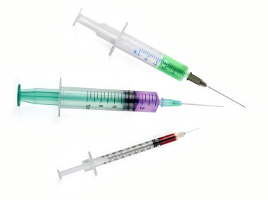medical tool syringe with colored liquids isolated on white
