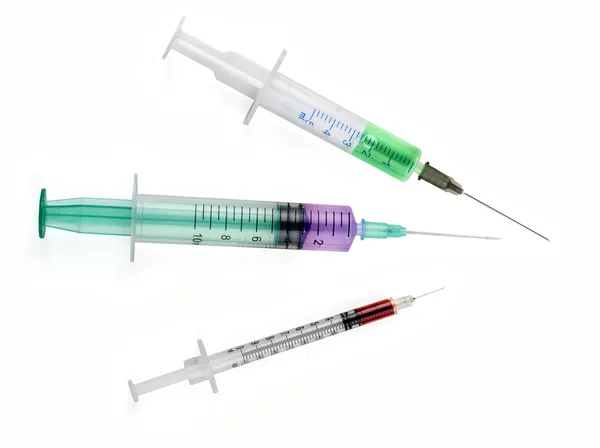 Medical tool syringe with colored liquids isolated on white Royalty Free Stock Images