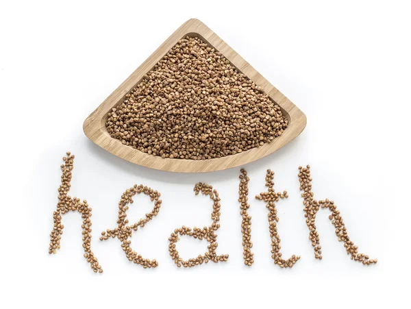 La parola "salute" fatta di chicchi di grano saraceno isolati su uno sfondo bianco — Foto Stock
