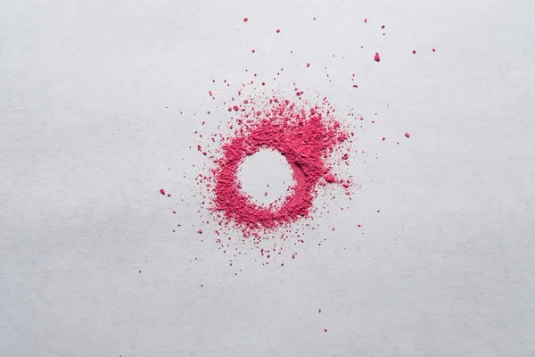 Cercle en poudre rouge sur fond blanc. Espace de copie. Peinture sèche avec une couleur vive. Vue du dessus. — Photo