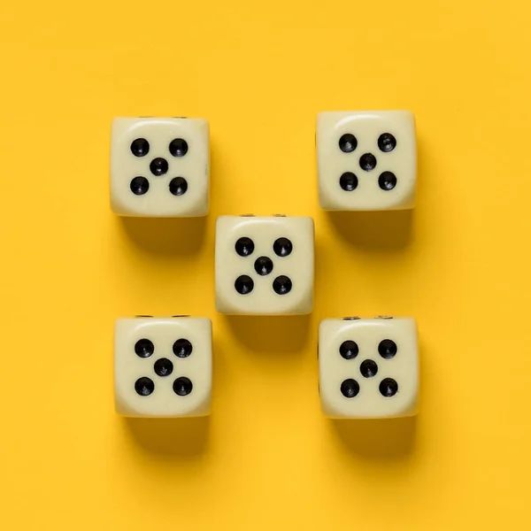 Ideally placed dice, their number and value are the same, on a yellow background. Top view. — Stock Photo, Image