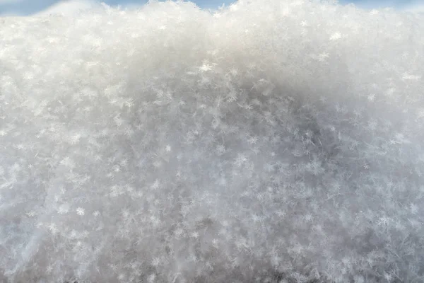 Los copos de nieve brillan en el sol, en la nieve esponjosa, en un día de invierno helado. Copiar espacio. Fondo abstracto. —  Fotos de Stock