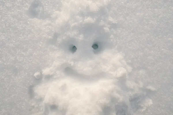 Schattig smiley gezicht dat eruit ziet als de Kerstman met een baard getekend op de sneeuw op een winterdag. Symbool van Kerstmis en Nieuwjaar. — Stockfoto