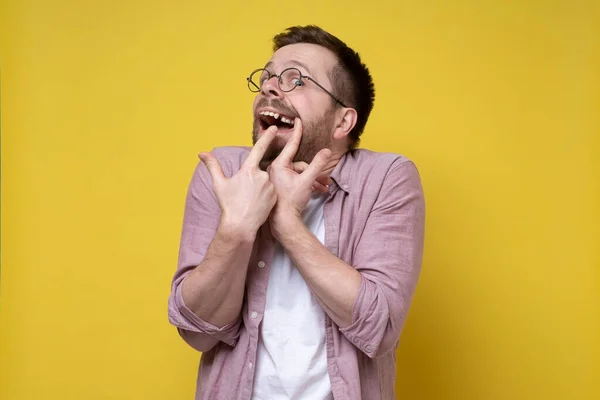 Man in glasses and casual clothes opened his mouth and shows a missing tooth with fingers. — Stock Photo, Image