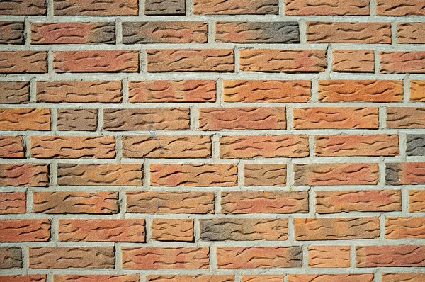 Fond texturé. Le mur est soigneusement doublé de pierre décorative qui ressemble à de la brique rouge. Espace de copie. — Photo