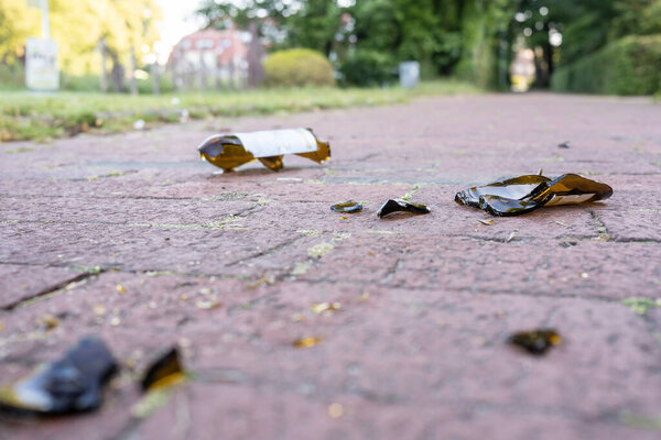 Broken glass bottles on the road in the early morning after a student booze