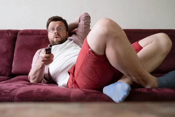 Man Holds Remote Control Lying Sofa Found Interesting Movie Pleasantly — Stock Photo, Image