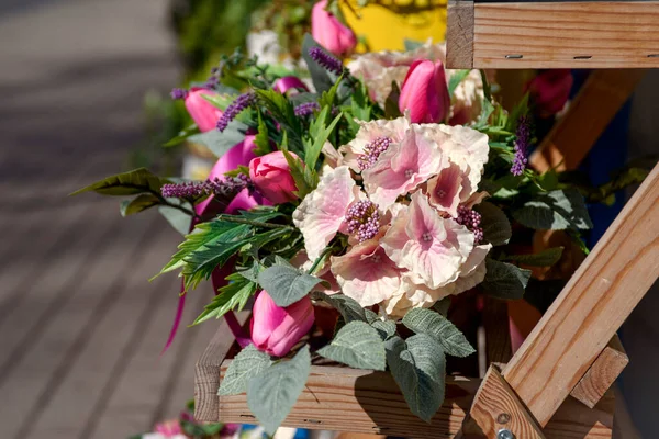 Dekoratif bir tencerede pembe laleler. Şehirde çiçekler var. Çiçeklerin üretimi ve yetiştirilmesi.