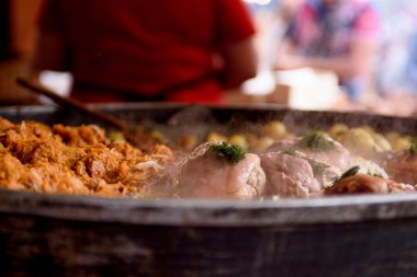 Cooking meat dishes in a summer restaurant on the street. Meat with greens close-up.