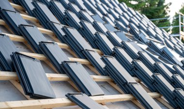 Stacks of new flat tiles on top of a private house.	