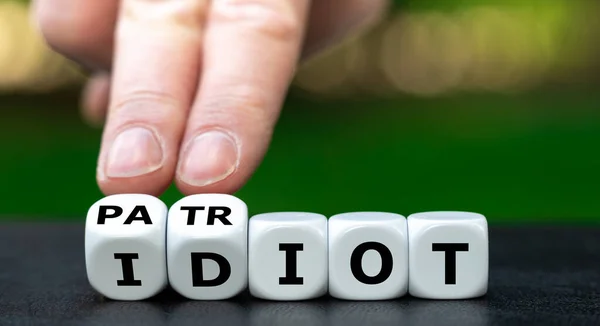 Hand Turns Dice Changes Word Idiot Patriot — Stok Foto