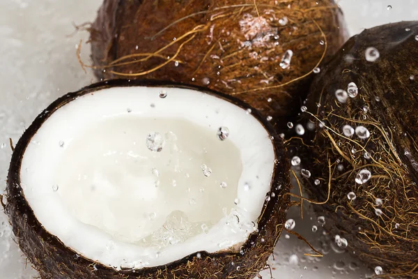 Coconuts and water splash — Stock Photo, Image