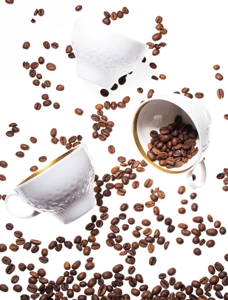 Falling coffee cups and beans — Stock Photo, Image