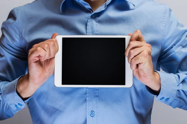 Man in blue shirt holding white tablet pc — Stock Photo, Image