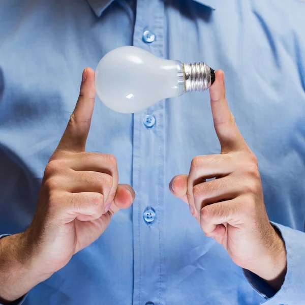 Hands with light bulb — Stock Photo, Image