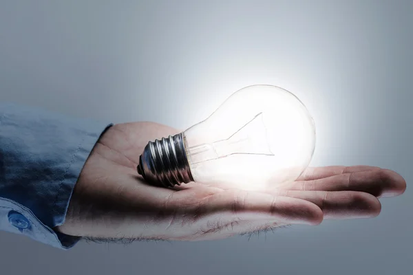 Hand with light bulb — Stock Photo, Image