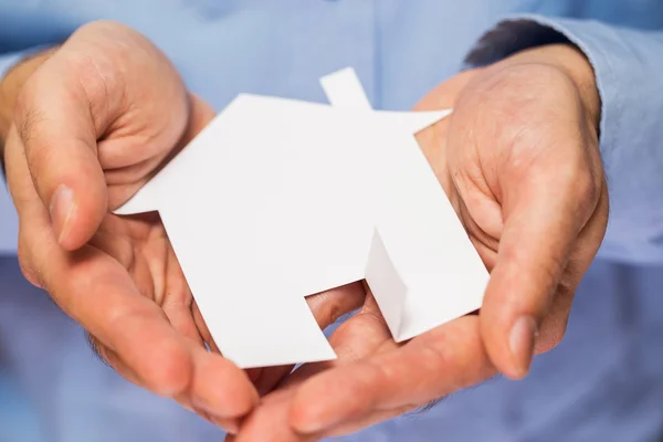 Man holding paper house in his hands — Stock Photo, Image