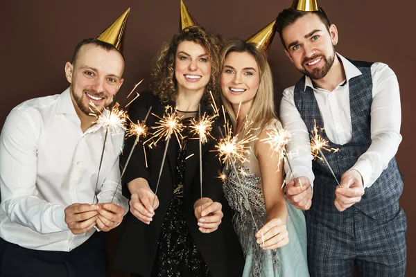 Group Happy People Wearing Party Hats Holding Burning Sparkles Holiday Stock Image