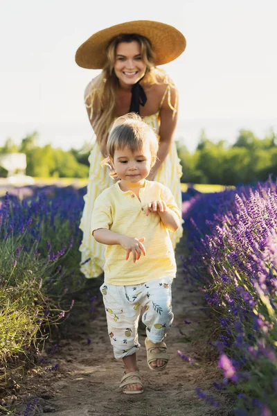 美しい若い女性と彼女のかわいいです息子でラベンダー畑 — ストック写真