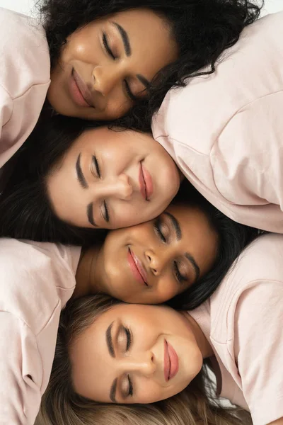 Group of different ethnicity women. Multicultural diversity and friendship. Female faces with different skin type and color.