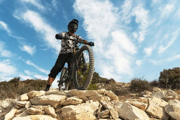 Professional bike rider during downhill ride on his bicycle in mountains