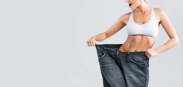 Woman Showing Result Weight Loss Wearing Old Jeans Gray Background — Stock Photo, Image