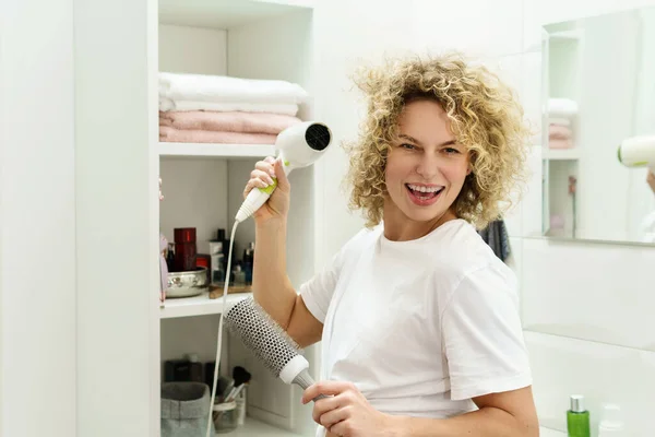 Young Happy Woman Using Hairdryer Her Curly Hair Bathroom — Stock Photo, Image