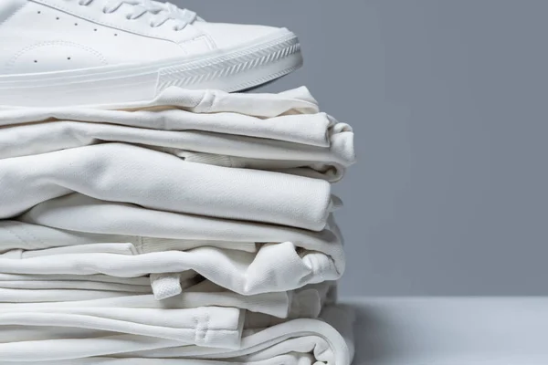 Stack White Clothes Stylish Trainers Gray Background — Stock Photo, Image