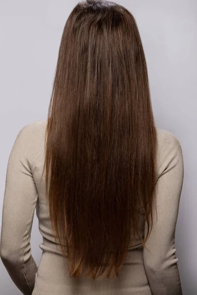 Jovem Mulher Mostrando Seu Cabelo Natural Marrom Saudável Fundo Cinza — Fotografia de Stock