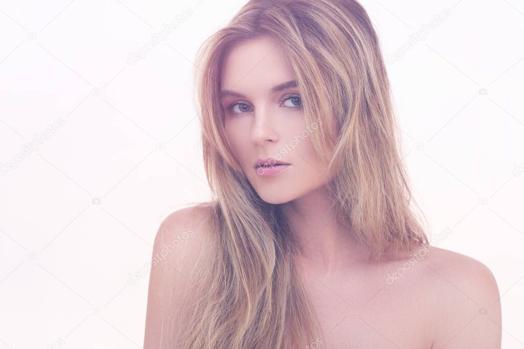 Portrait of young beautiful blonde woman with smooth skin in studio