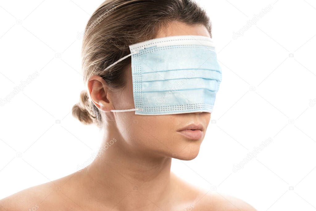 Young woman wearing prevention mask on her eyes. Concepts of conspiracy theory or misinformation about Covid-19 pandemic.