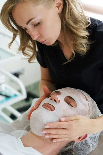 Female Cosmetologist Applying Sheet Mask Client Face Beauty Clinic — Stock Photo, Image