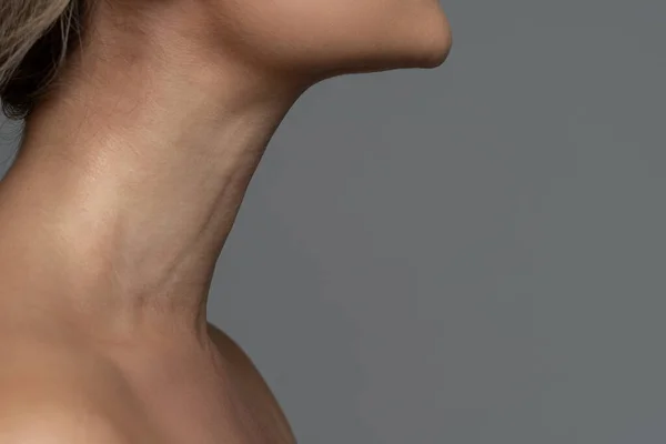 Closeup of female neck with a smooth skin. Skin-care and anti-aging treatments for aging neck