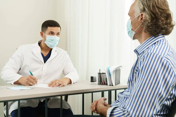 Doctor Middle Aged Male Patient Wearing Prevention Masks Consultation Office Royalty Free Stock Photos