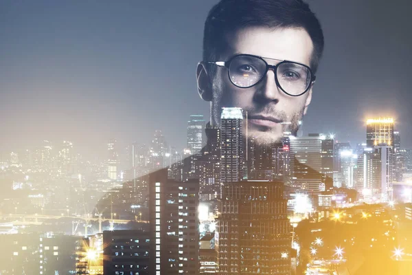 Creative photo of young intelligent man and overlaid city landscape