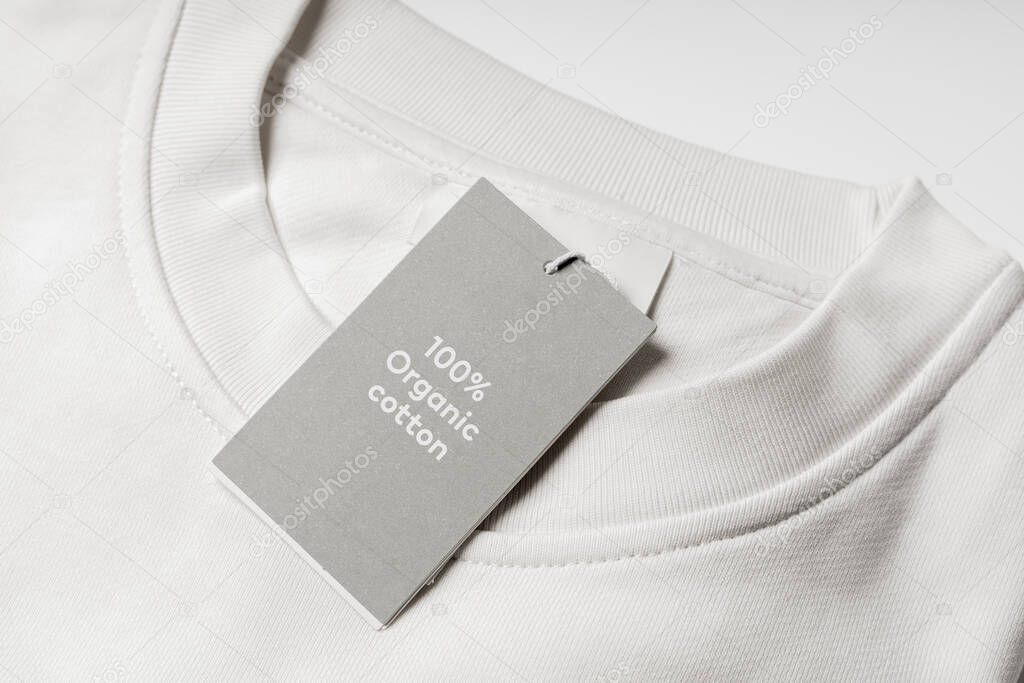 Close-up of paper label on a white 100% organic cotton clothing
