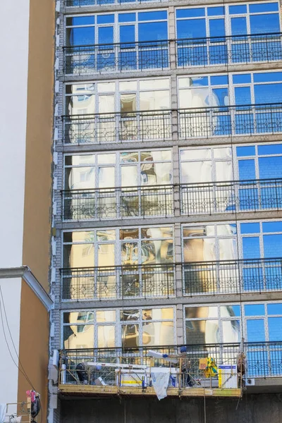 Building and Construction site of new home. House under construction at building site. Glazed balconies of house in facade.