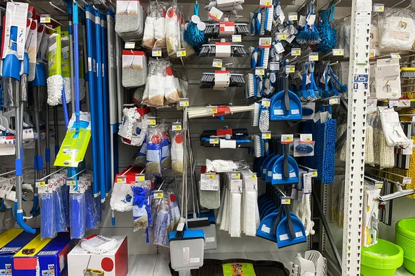 Tools for cleaning in the store. Shopping with background of blue equipments on shelf in shop.