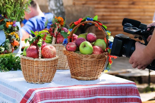 Filming a video of apples in wicker baskets in a peasant style. Rural blogging.