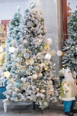 Noel hediyeleri ve dekorasyon oyuncakları mağazada satılığa çıkarıldı. Alışveriş merkezinde çeşitli beyaz dekorasyonlar. Yeni Yıl.