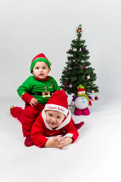 Santa claus en santa's helper baby jongens Stockfoto