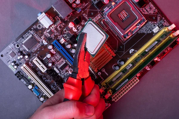 high performance personal computer repair, processor insertion, processor into motherboard socket, red neon ligh