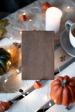 autumn decor wooden frame place for text. concept for postcard holiday halloween. copyspace. pumpkins and candles on a white backgroun