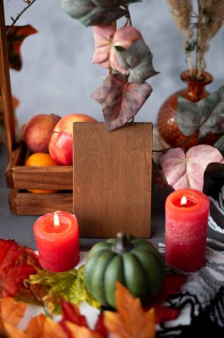 autumn decor wooden frame place for text. concept for postcard holiday halloween. copyspace. pumpkins and candles on a white backgroun
