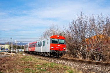 BRATISLAVA, SLOVAKIA - MARCH 03, 2022. Train #80-73 114-5 (Austria) riding with passengers in the streets of Bratislava.