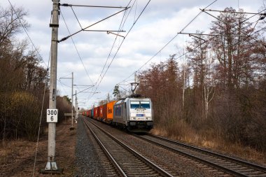 PARDUBICE, CZECH REPUBLIC - February 23, 2022. Locomotive Bombardier Traxx F140 MS 2 e #386 014-5 riding with passengers in the streets of Pardubice.