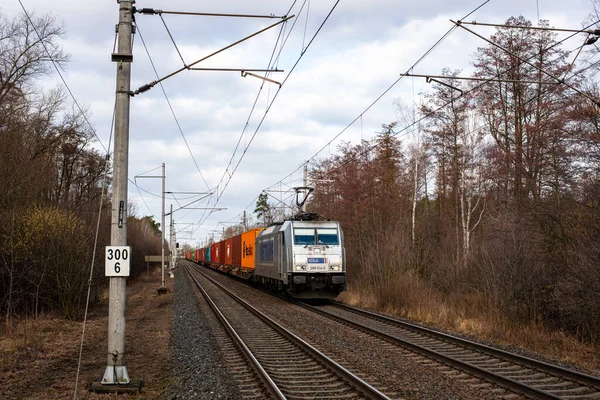 PARDUBICE, CZECH REPUBLIC - February 23, 2022. Locomotive Bombardier Traxx F140 MS 2 e #386 014-5 riding with passengers in the streets of Pardubice.