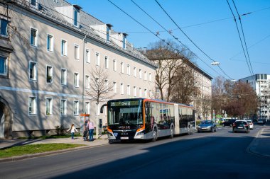 LINZ, AUSTRIA - MARCH 26, 2022. Bus MAN 18C Lions City NG360 #102 riding with passengers in the streets of  Linz.