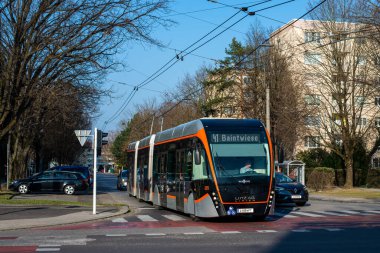 LINZ, AUSTRIA - MARCH 26, 2022. Trolleybus Van Hool Exqui.City 24 #225 riding with passengers in the streets of  Linz.